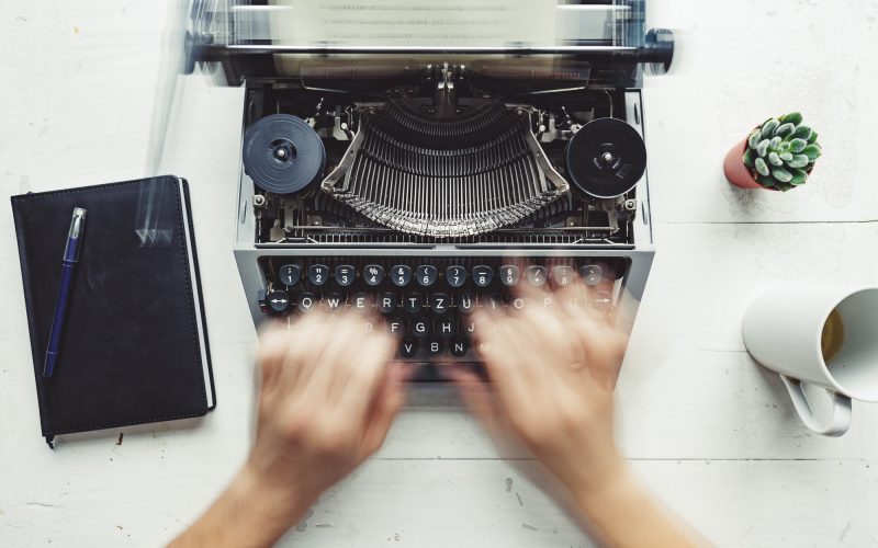 Writer typing with retro writing machine. Writer typing with retro writing machine.